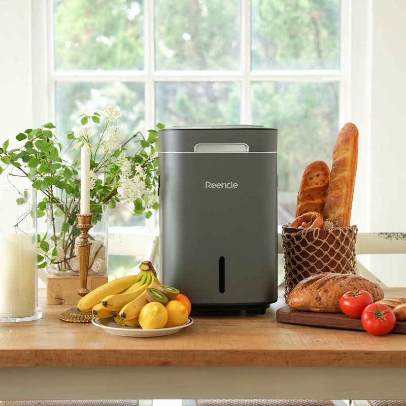 komposter-reencle-prime-kuhinja Sivi Reencle Prime komposter na stolu s hranom – elegantno rješenje za kućno kompostiranje bez muke